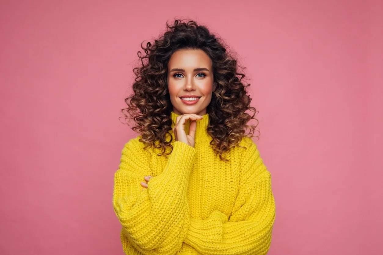 Stylish woman poses confidently in sweater