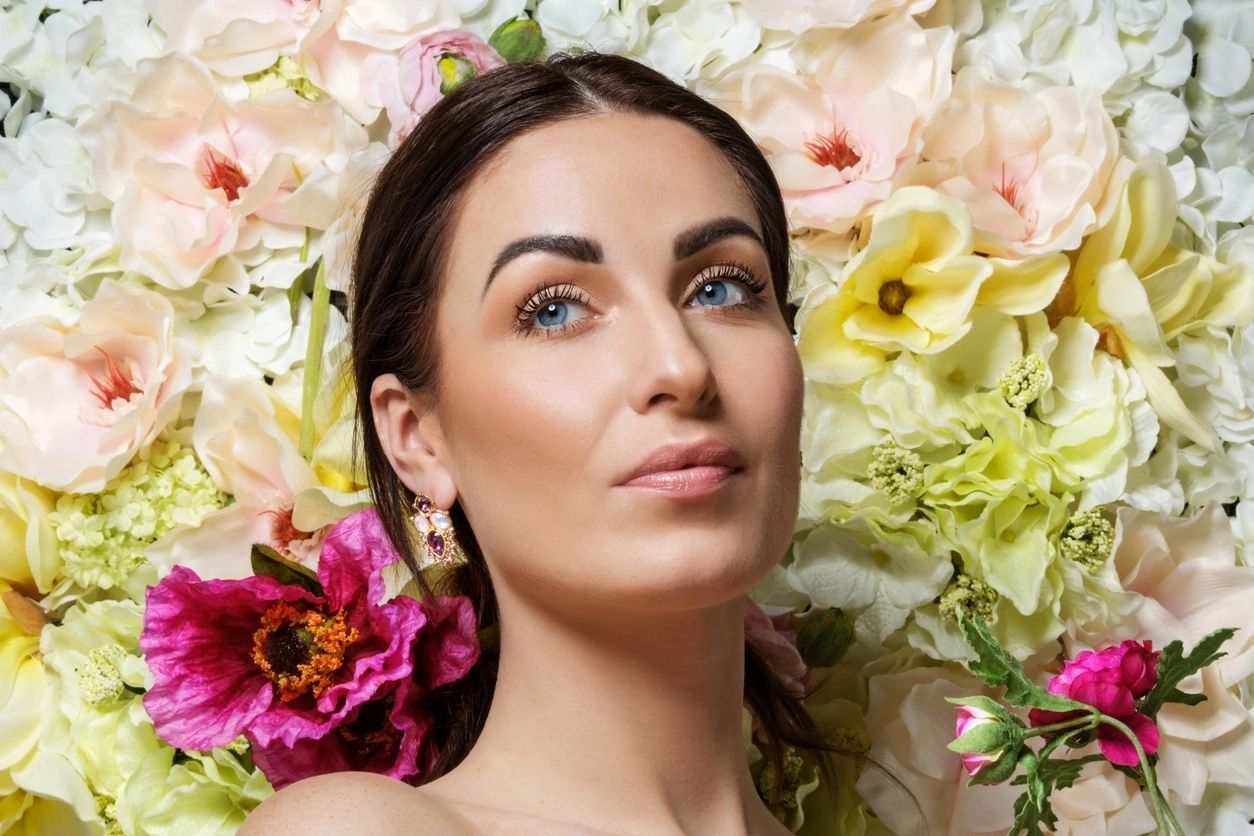 Elegant woman against floral backdrop